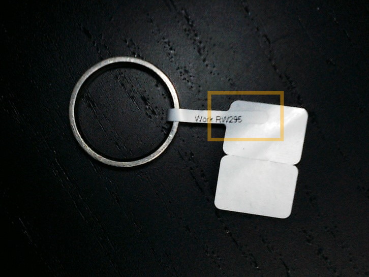 A key chain with a tag on itDescription automatically generated