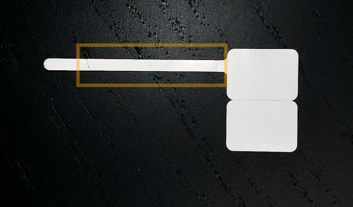 A white rectangular object with a yellow borderDescription automatically generated