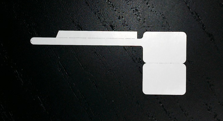 A white object on a black surfaceDescription automatically generated